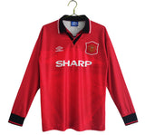A long sleeve red Manchester United soccer jersey with a Sharp sponsor logo and Umbro brand logo.