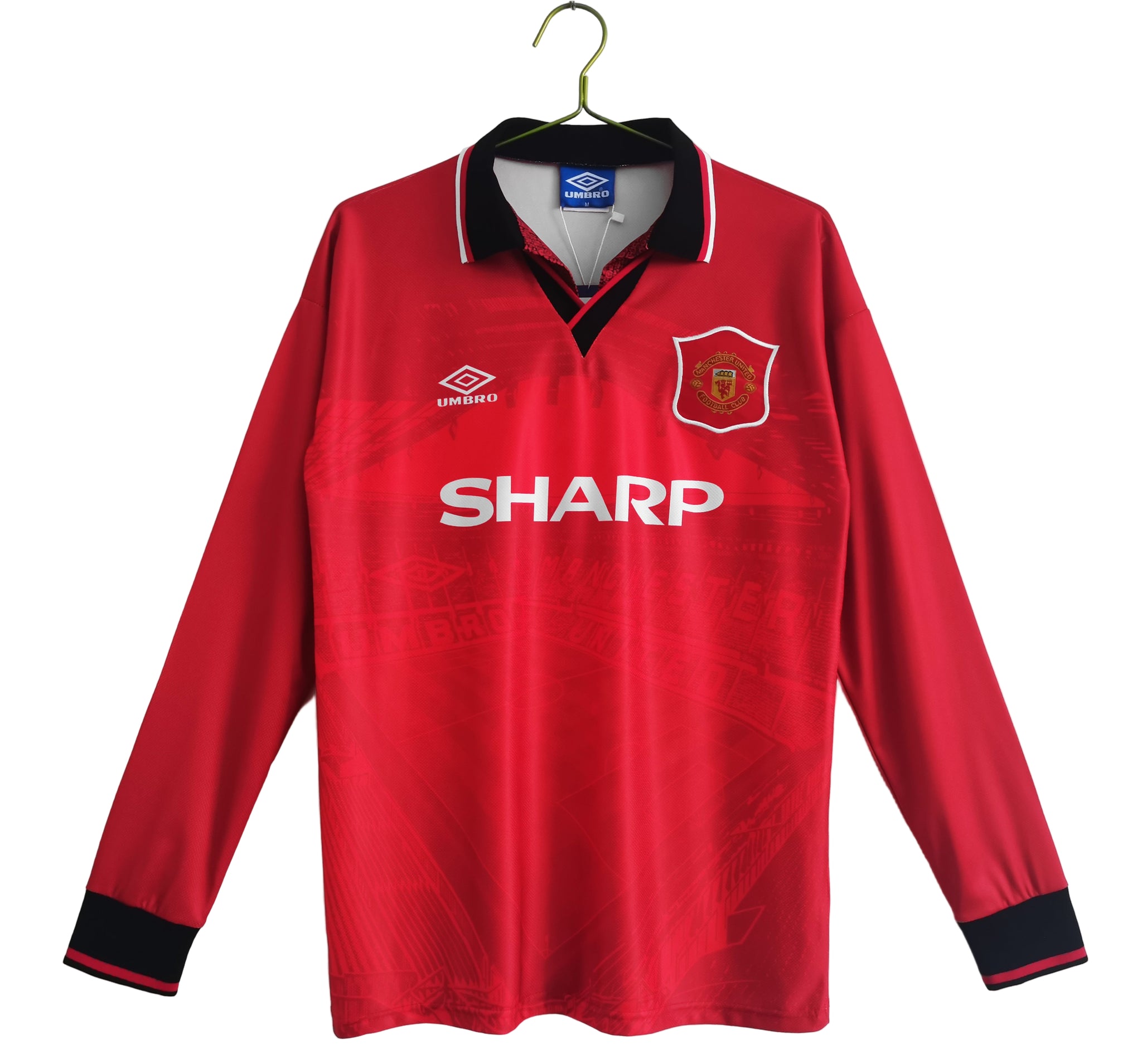 A long sleeve red Manchester United soccer jersey with a Sharp sponsor logo and Umbro brand logo.