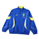Blue and yellow jacket with a logo on a green sports field background