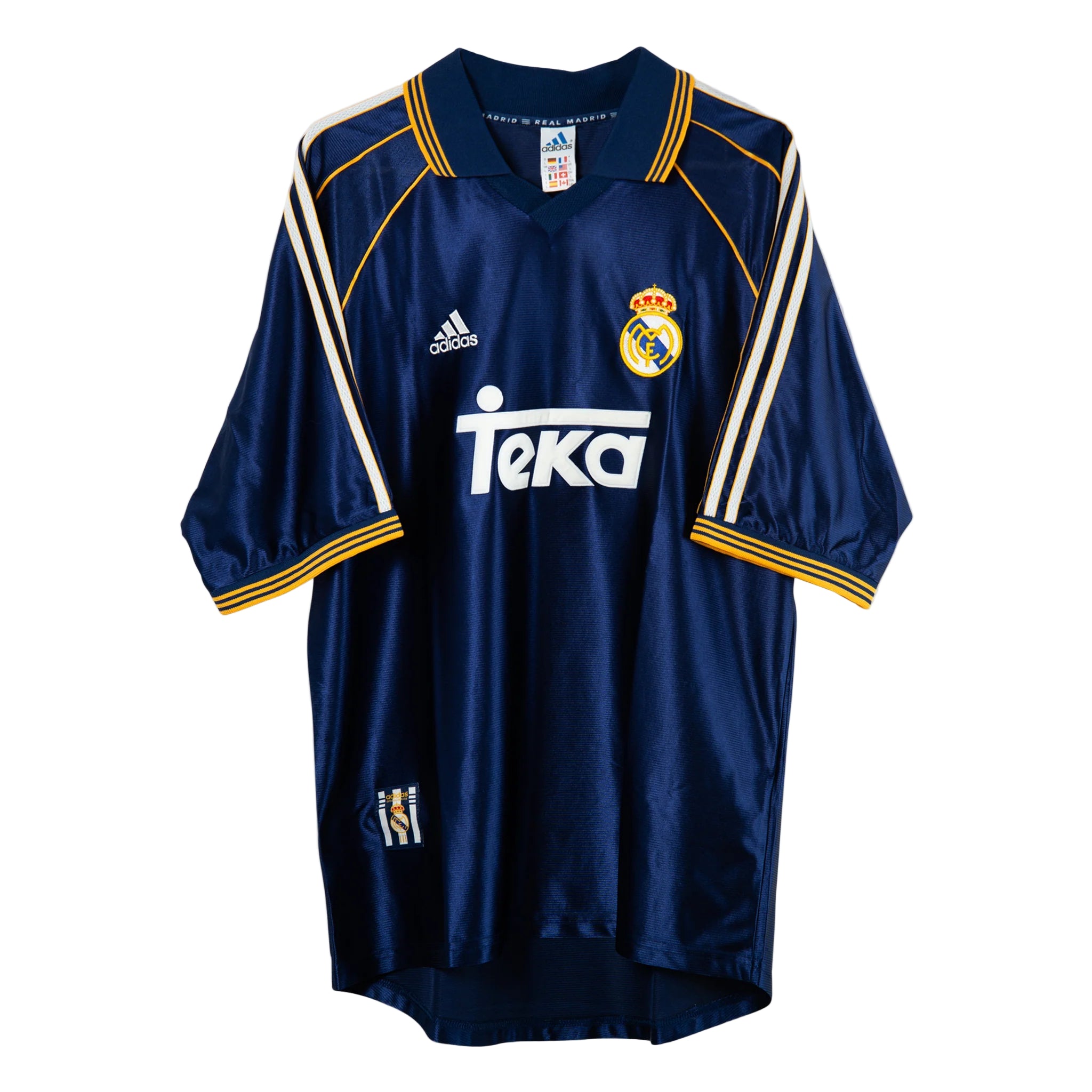 A navy blue soccer jersey with white and yellow accents, featuring the Real Madrid crest and the Teka sponsor logo.